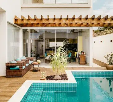 brown wooden table near swimming pool