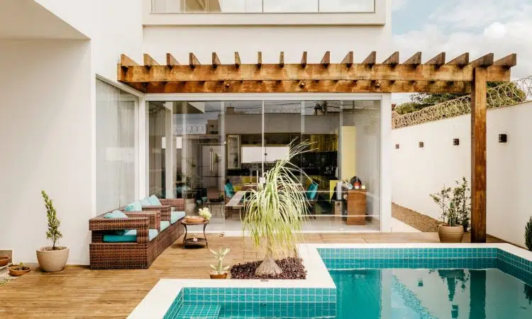 brown wooden table near swimming pool